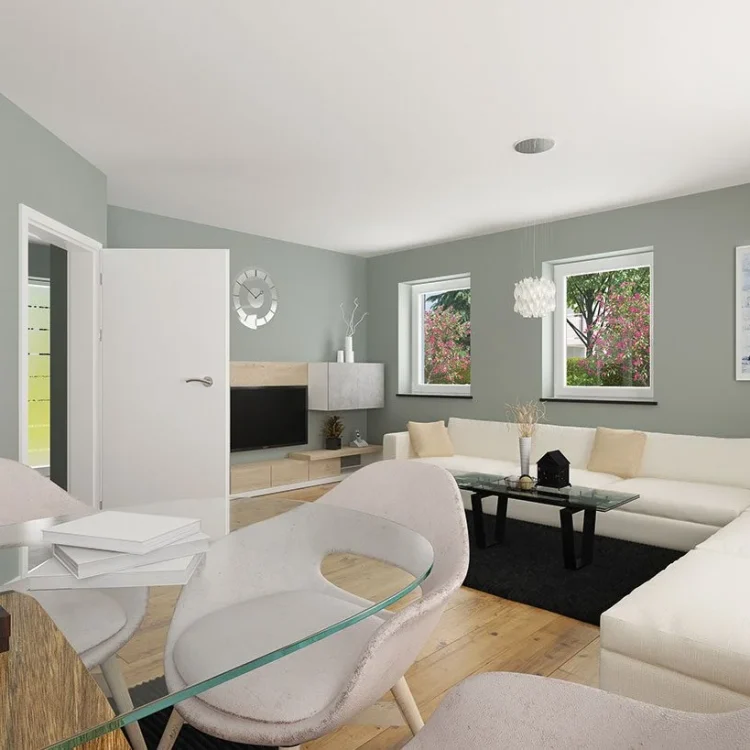 Modernes Wohnzimmer mit weißer Eckcouch, grünen Wänden, Holzboden und offener Verbindung zum Essbereich