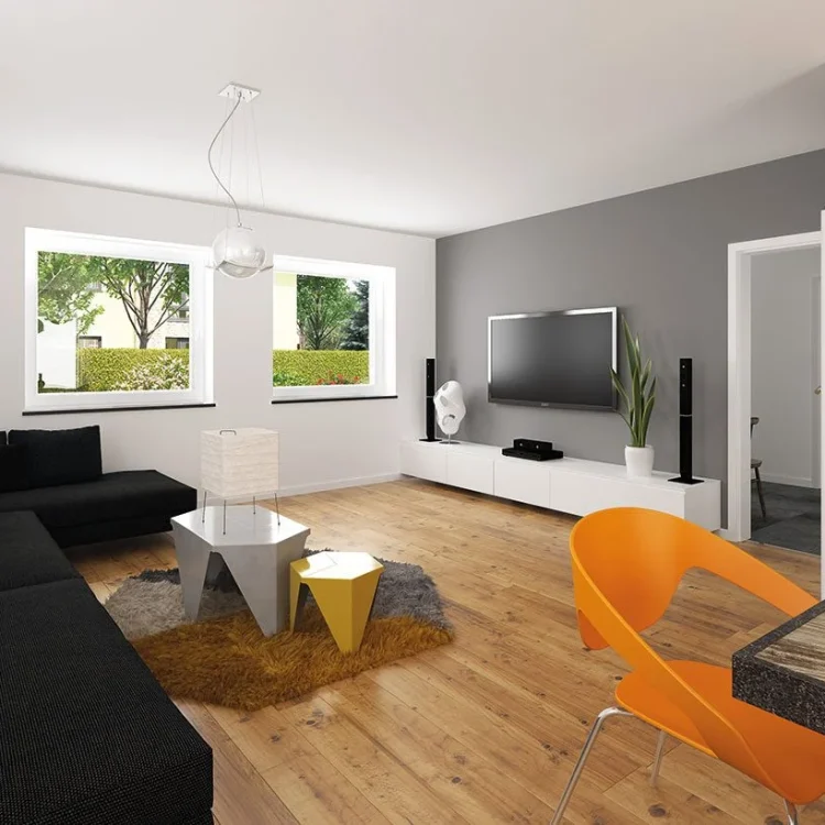 Modernes Wohnzimmer mit schwarzem Ecksofa, TV-Wand, orangem Designstuhl und Parkett in hellem Ambiente