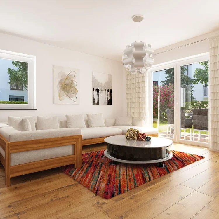 Modernes Wohnzimmer mit beiger Eckcouch, rundem Couchtisch, buntem Teppich und Zugang zur Terrasse