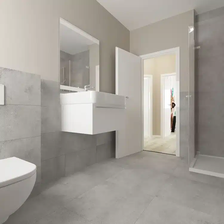 Modernes Badezimmer mit grauer Wandgestaltung, weißem Waschbecken, WC und begehbarer Dusche in Stadtvilla SV 125