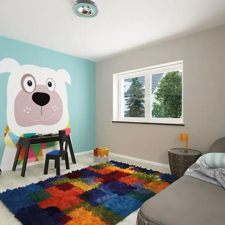 Kinderzimmer mit mintgrüner Wand, Hundewandtattoo, buntem Teppich und grauem Sessel in moderner Stadtvilla